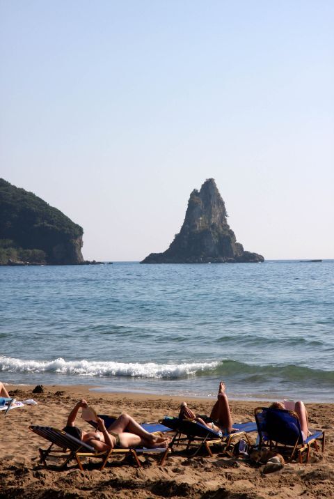 Three girls sunabathing at Agios Gordios Beach