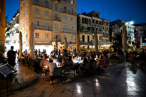 Night view of restaurants in a square of Corfu Town