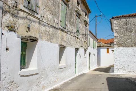 Agios Leon: Two floored houses with green colored shutters.